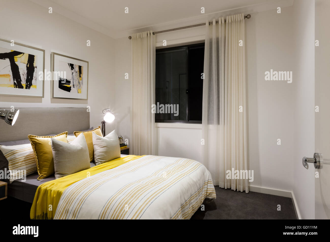Classic bedroom of a modern house with table lamps on next to pillows