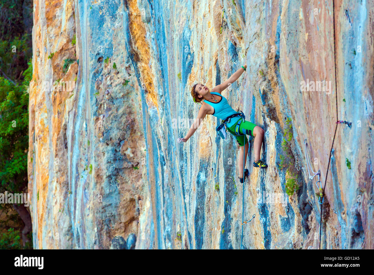 Young Female Climber ascending vertical rocky wall Stock Photo Alamy