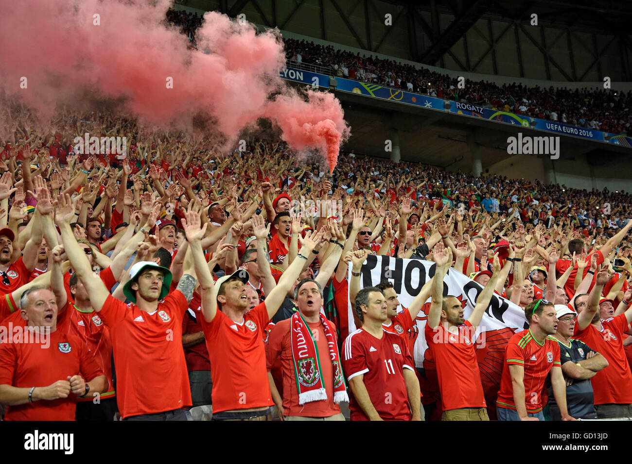 Welsh fans sing the Welsh national anthem at the Welsh Football team after defeat in the Euro 2016 Semi-Final between Portugal and Wales at the Parc Olympique Lyonnais in Lyon, France. Stock Photo