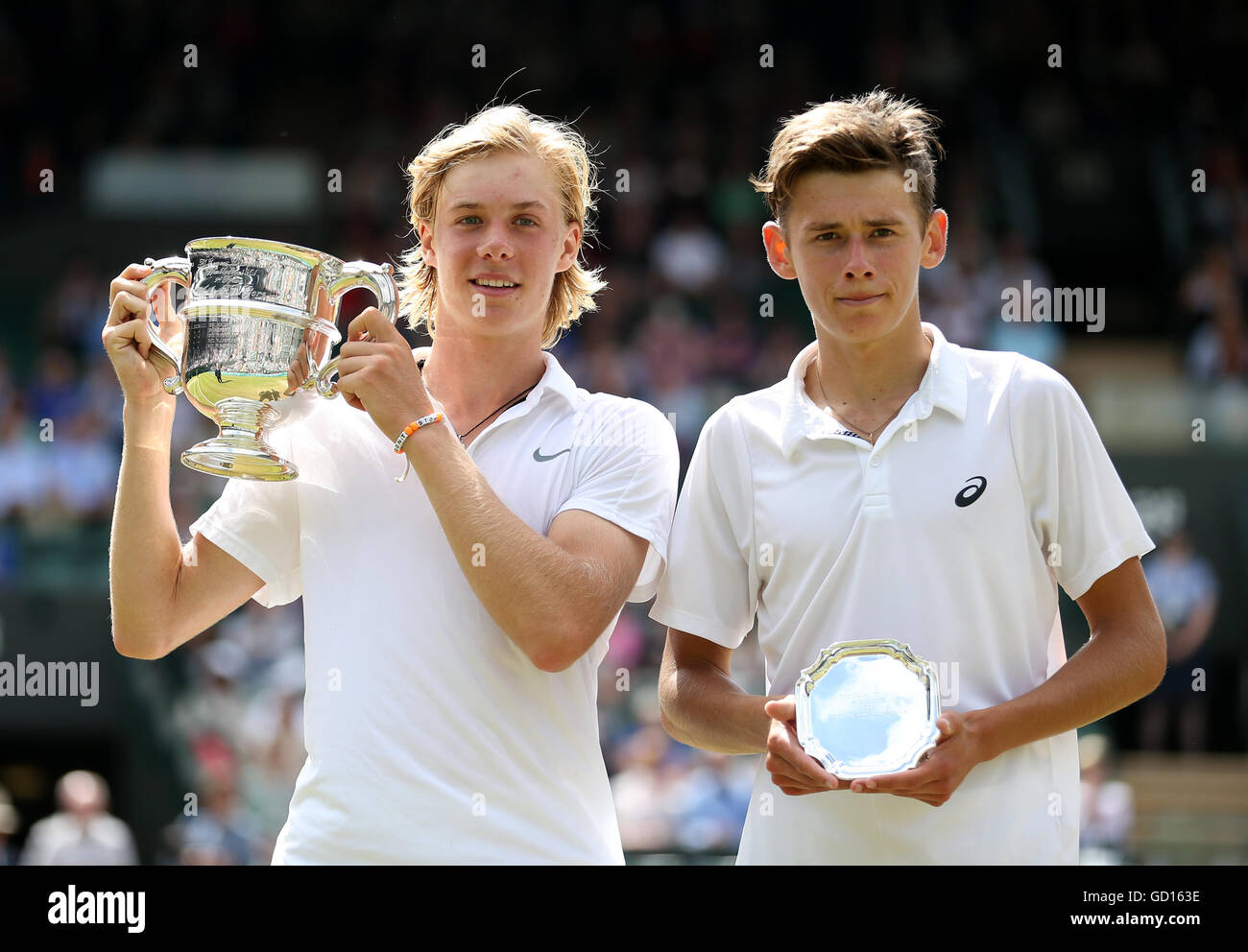 denis-shapovalov-right-poses-with-his-trophy-after-winning-the-boys-GD163E.jpg