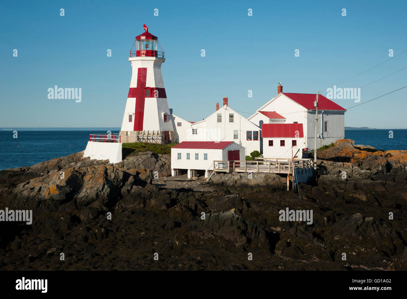 Head Harbor lighthouse is a Canadian beacon with its unique painted cross, located around the lowest tides on the East Coast. Stock Photo