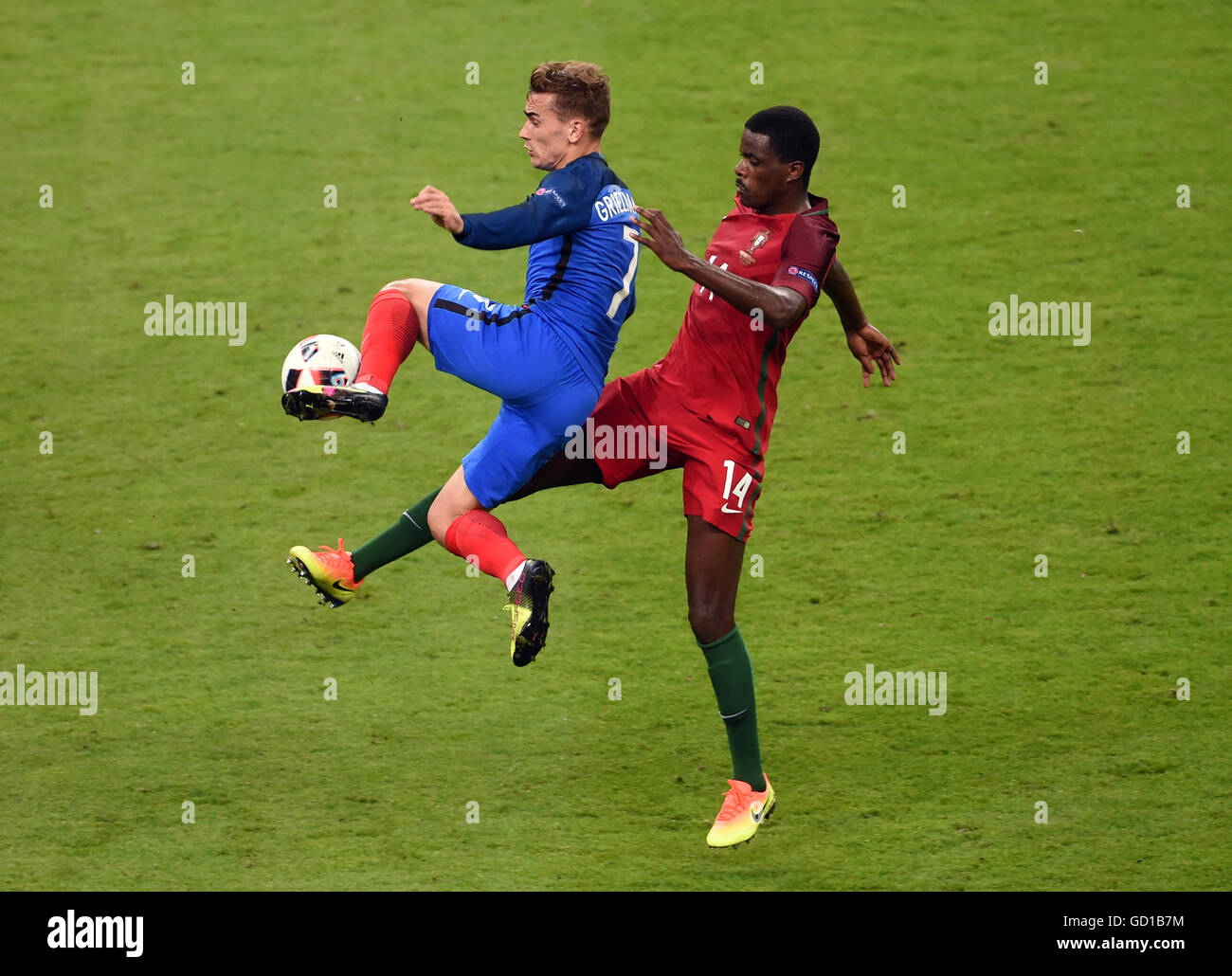 France's Antoine Griezmann (left) and Portugal's William Carvalho battle for the ball during the UEFA Euro 2016 Final at the Stade de France, Paris. Stock Photo