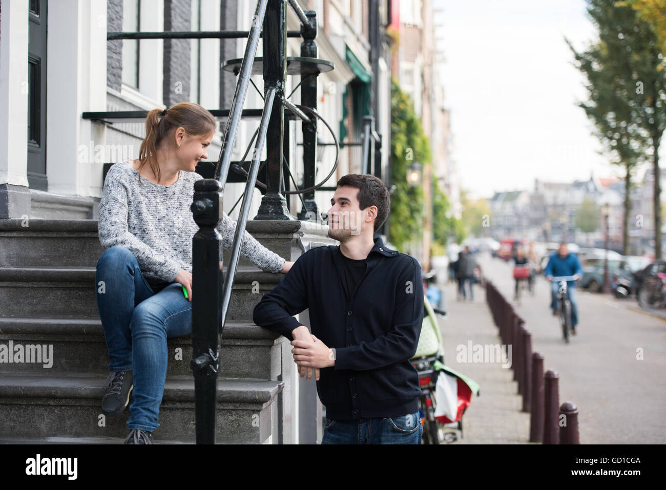 Couple sitting on stairs hi-res stock photography and images - Alamy