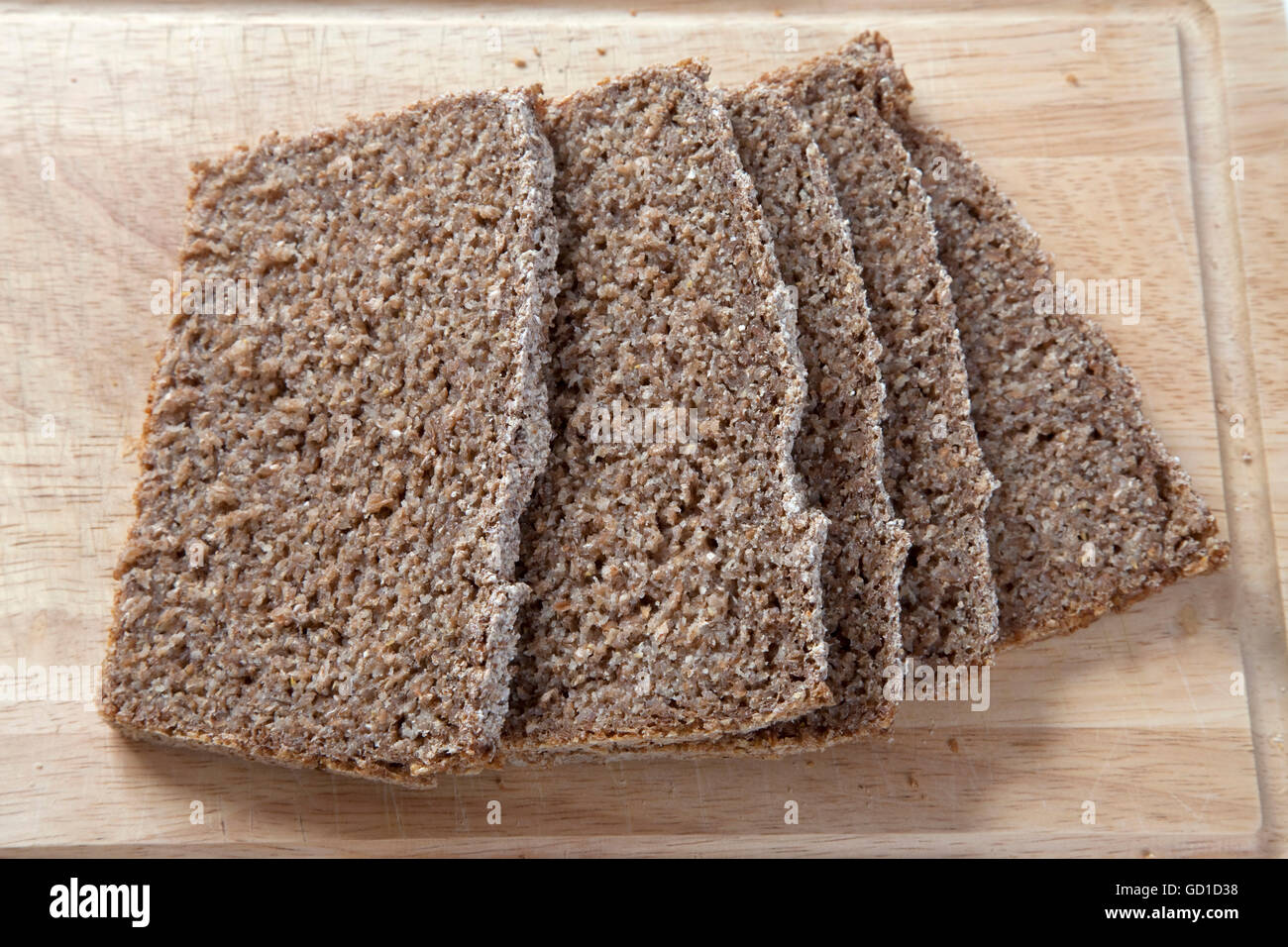Slices of whole grain bread on a wooden board Stock Photo