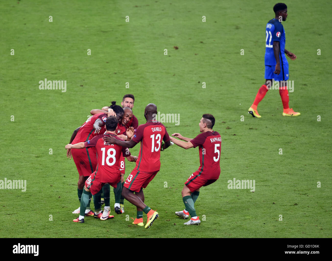 Portugal players celebrate after Eder (left, obscured) scores his side's first goal of the game during the UEFA Euro 2016 Final at the Stade de France, Paris. Stock Photo
