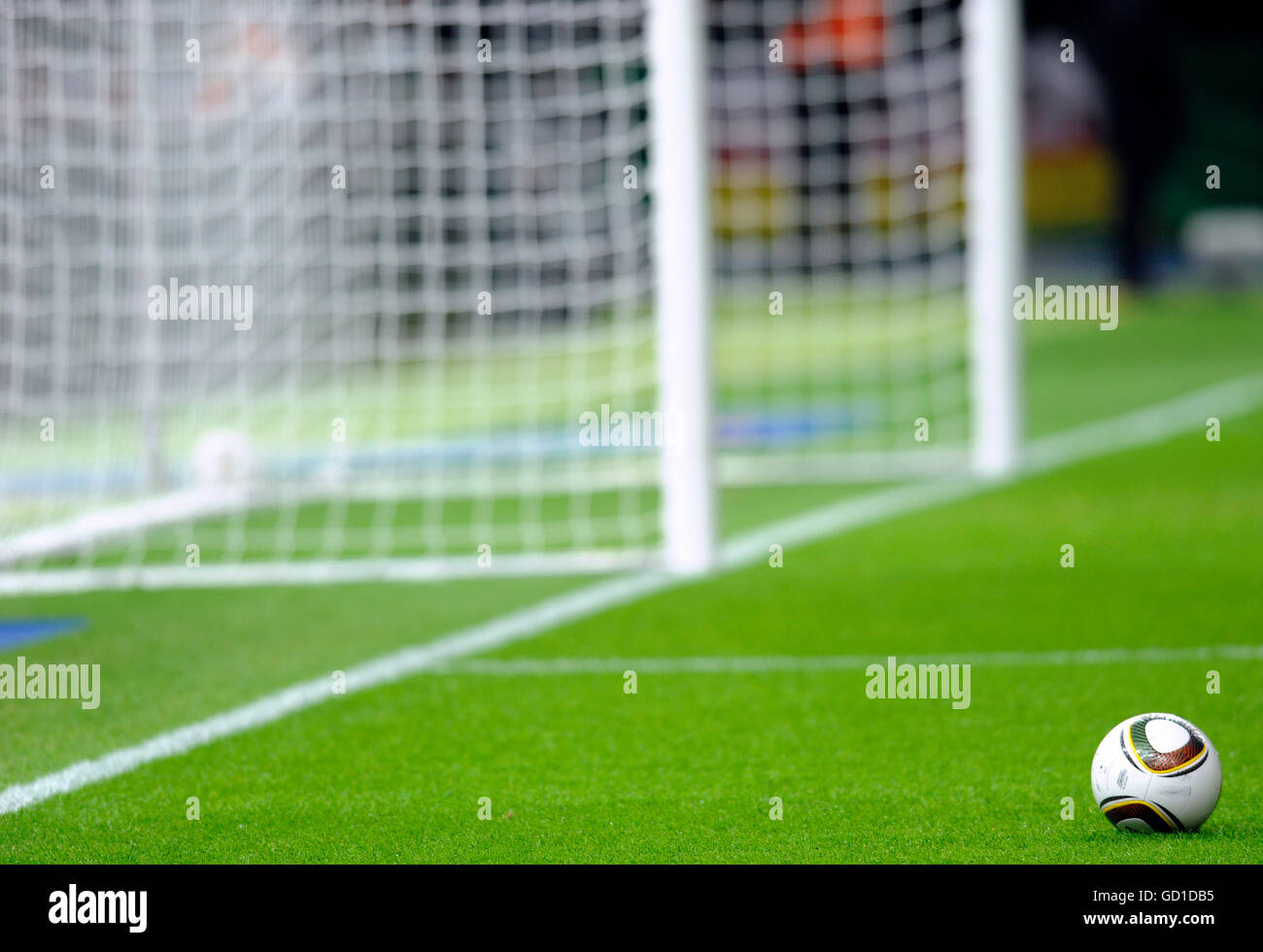 Adidas Jabulani football in front of an empty goal Stock Photo