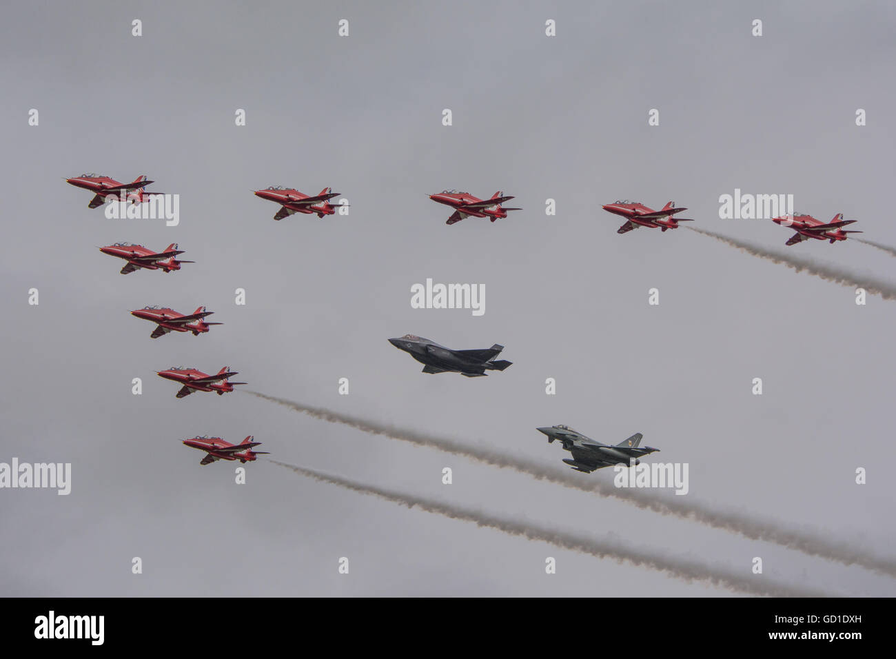 The Red Arrows in formation with a F-35B Lightning II and a Typhoon FGR4. Stock Photo