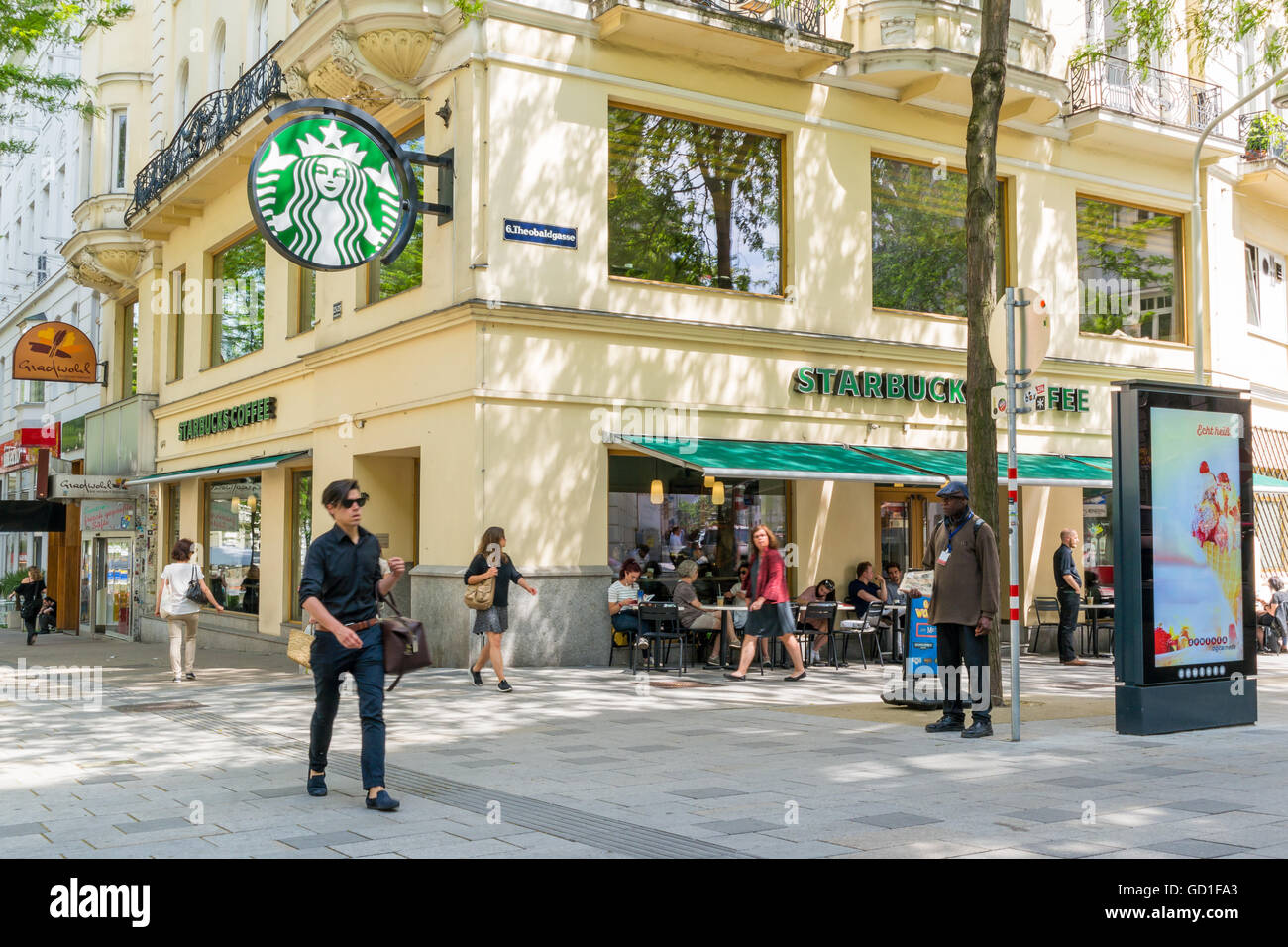 People and Starbucks cafe in shopping street Mariahilfer Strasse in Vienna, Austria Stock Photo