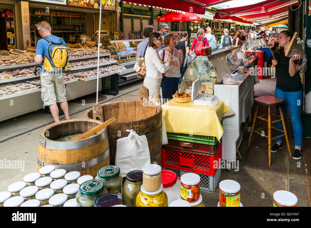 People buying food at market stands on Naschmarkt in Vienna, Austria Stock Photo