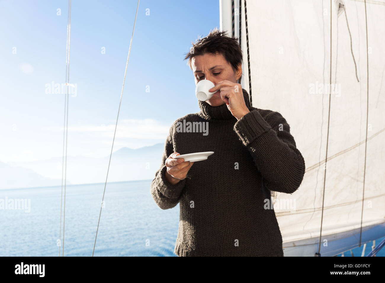 woman makes a coffee break aboard his sailboat Stock Photo Alamy