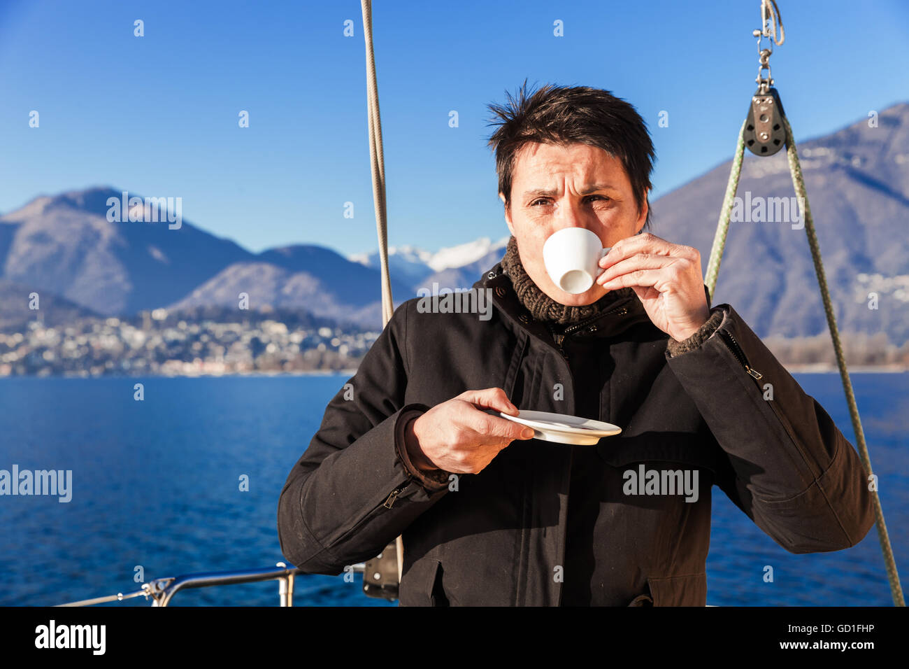 woman makes a coffee break aboard his sailboat Stock Photo