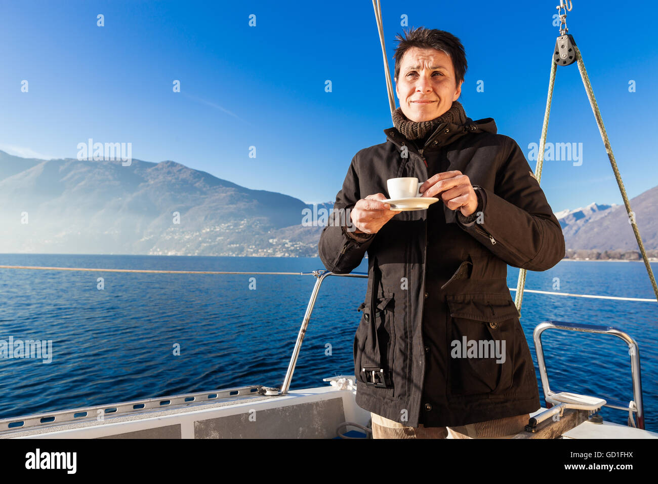 woman makes a coffee break aboard his sailboat Stock Photo Alamy