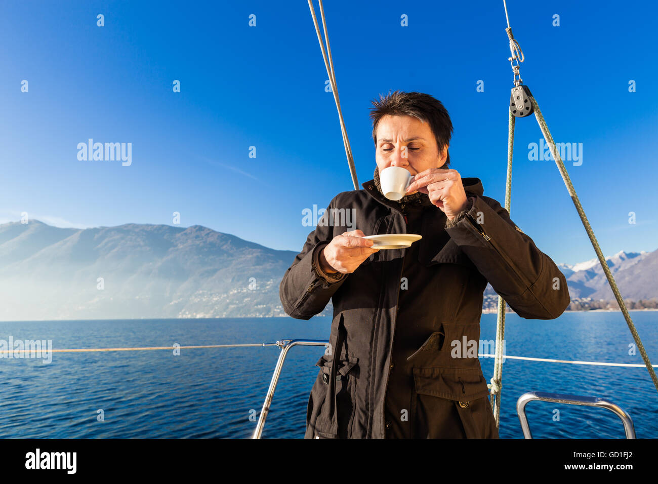 woman makes a coffee break aboard his sailboat Stock Photo Alamy