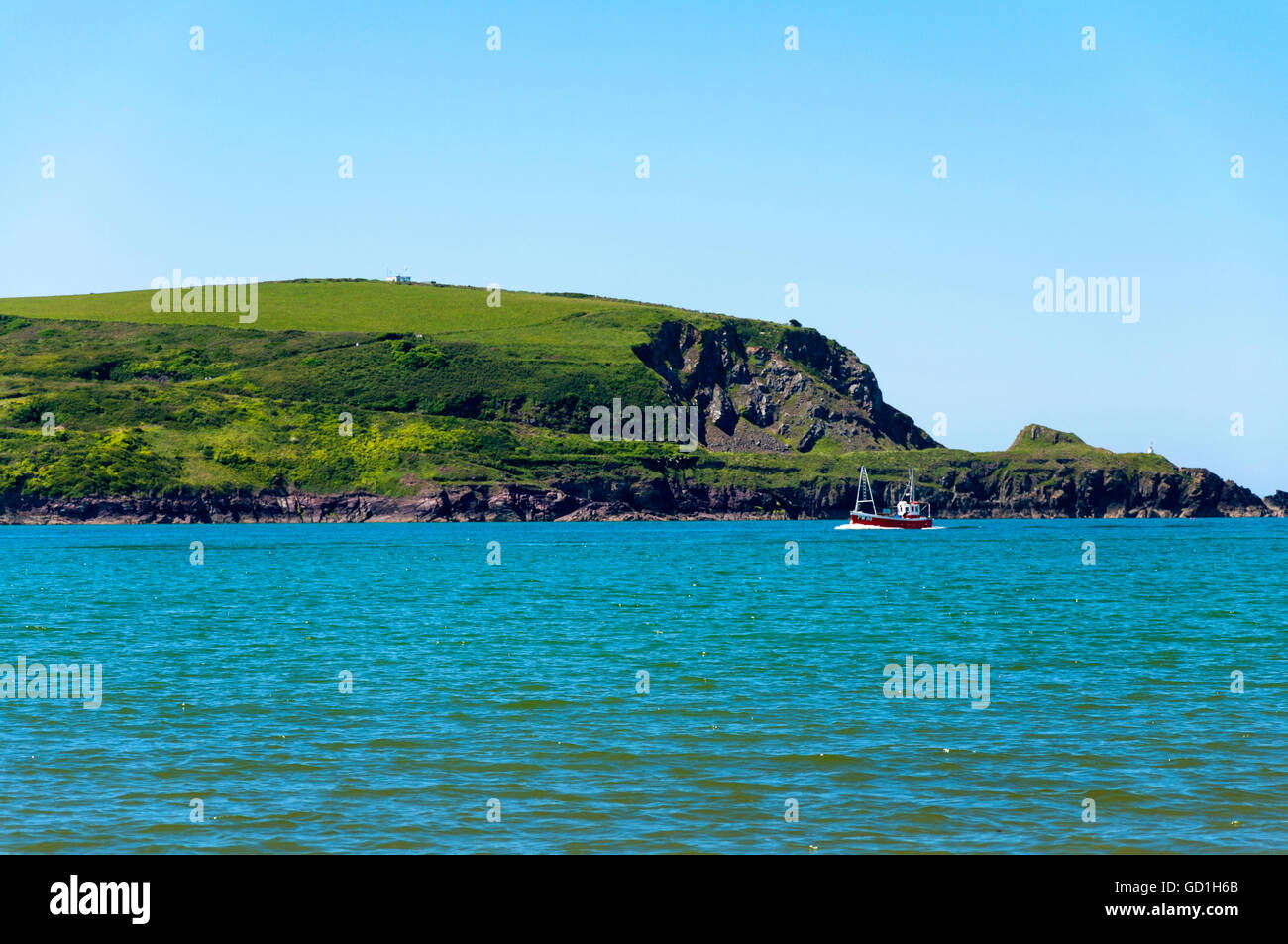 A fishing boat makes way in Daymer Bay in  River Camel estuary in north Cornwall, England, UK Stock Photo