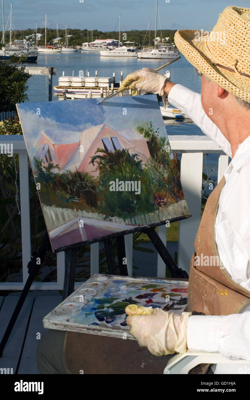 Woman painter painting the Hope Town Harbour. Hope Town, Elbow Cay, Abacos. Bahamas Stock Photo