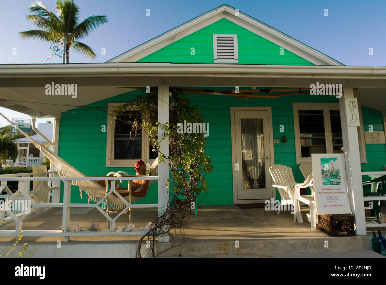 Typical loyalist house, Hope Town, Elbow Cay, Abacos. Bahamas. Relaxing in a hammock. Stock Photo