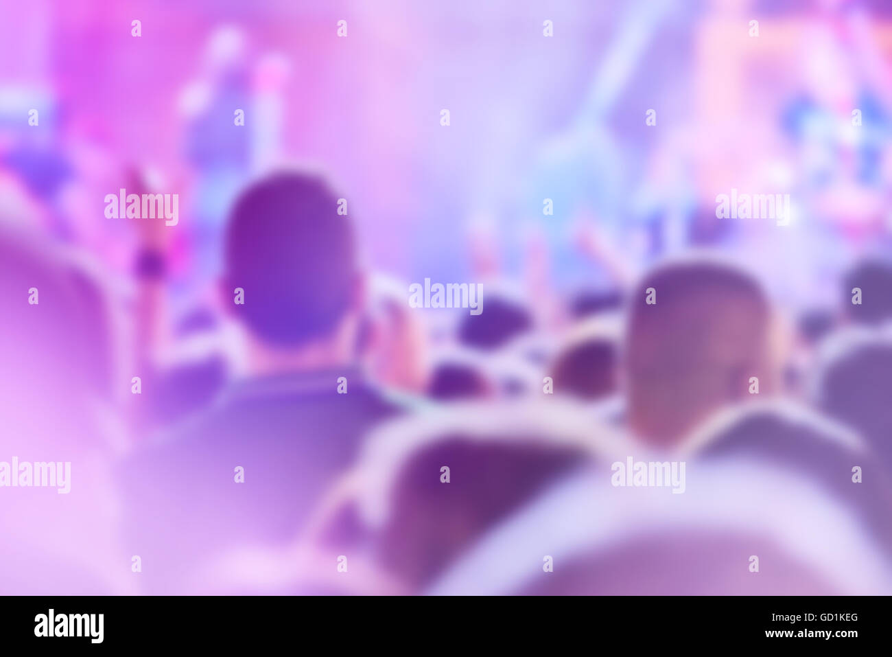 Popular rock music concert crowd out of focus, blur unrecognizable group of people listening to live performance on festival Stock Photo