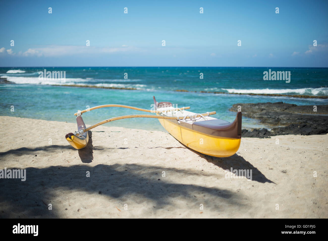 Outrigger canoe on the beach; Island of Hawaii, Hawaii, United States of America Stock Photo