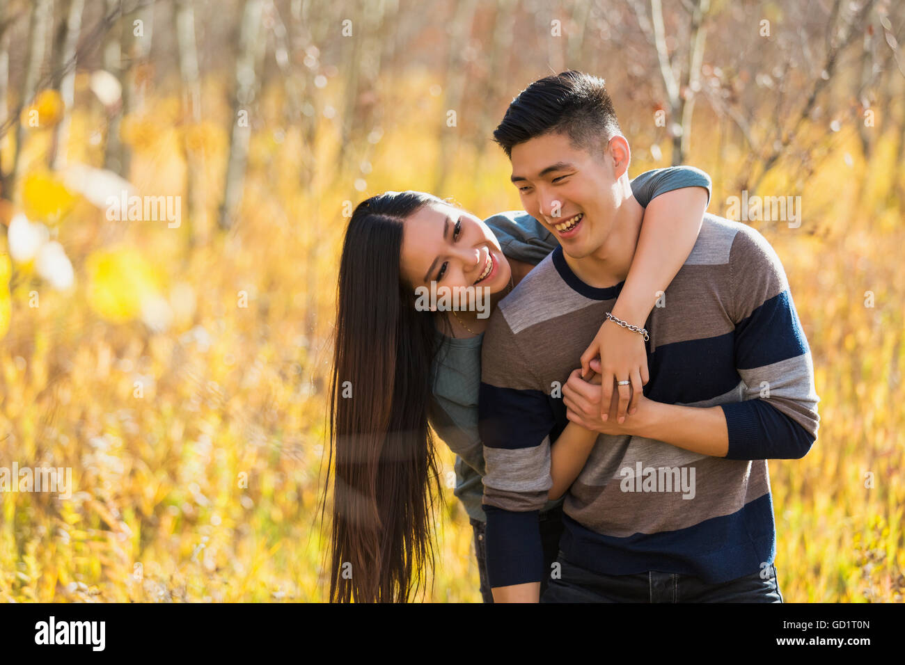 A Young Asian Couple Enjoying Quality Time Together Outdoors In A Park ...