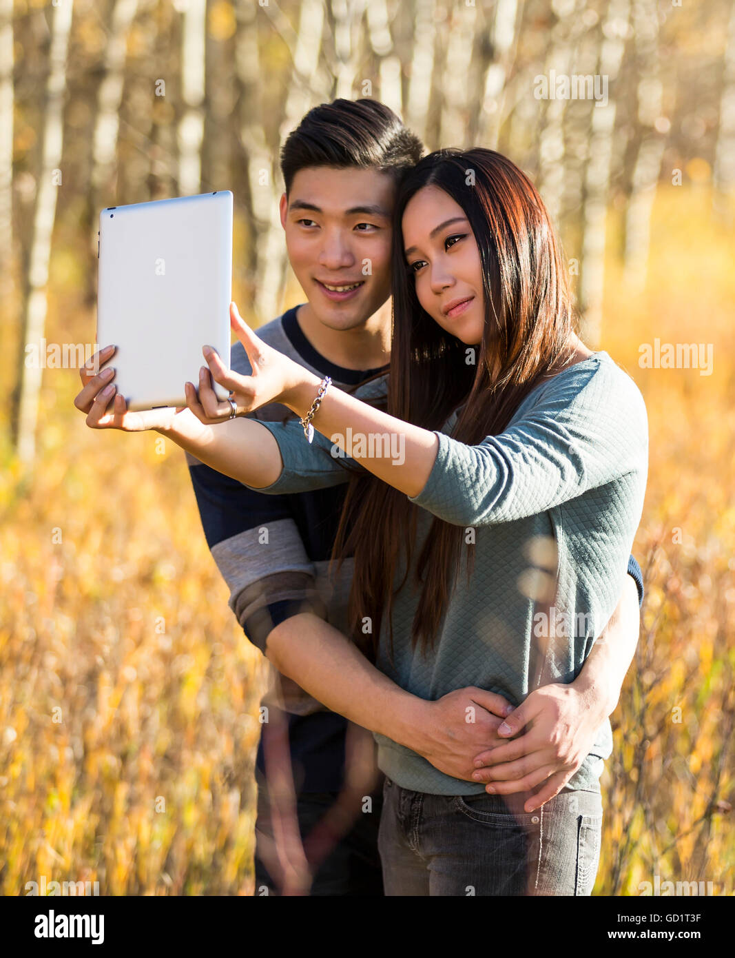 A Young Asian Couple Enjoying Quality Time Together Outdoors In A Park ...
