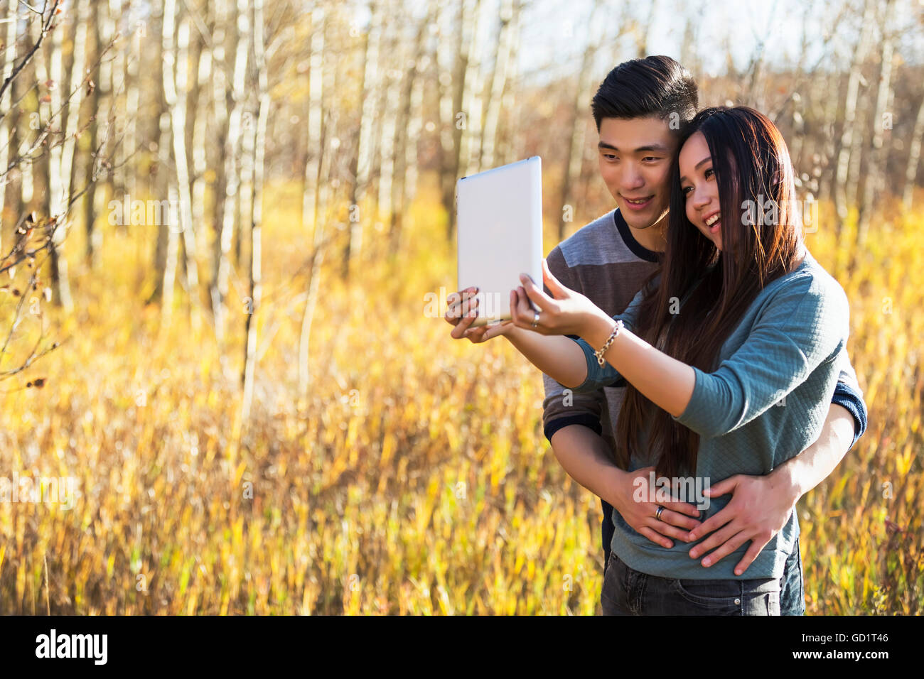 A Young Asian Couple Enjoying Quality Time Together Outdoors In A Park ...