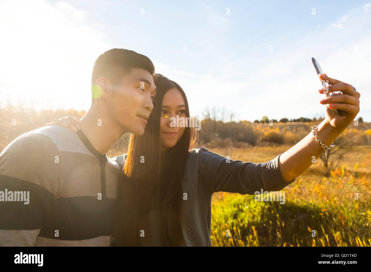 A Young Asian Couple Enjoying Quality Time Together Outdoors In A Park ...