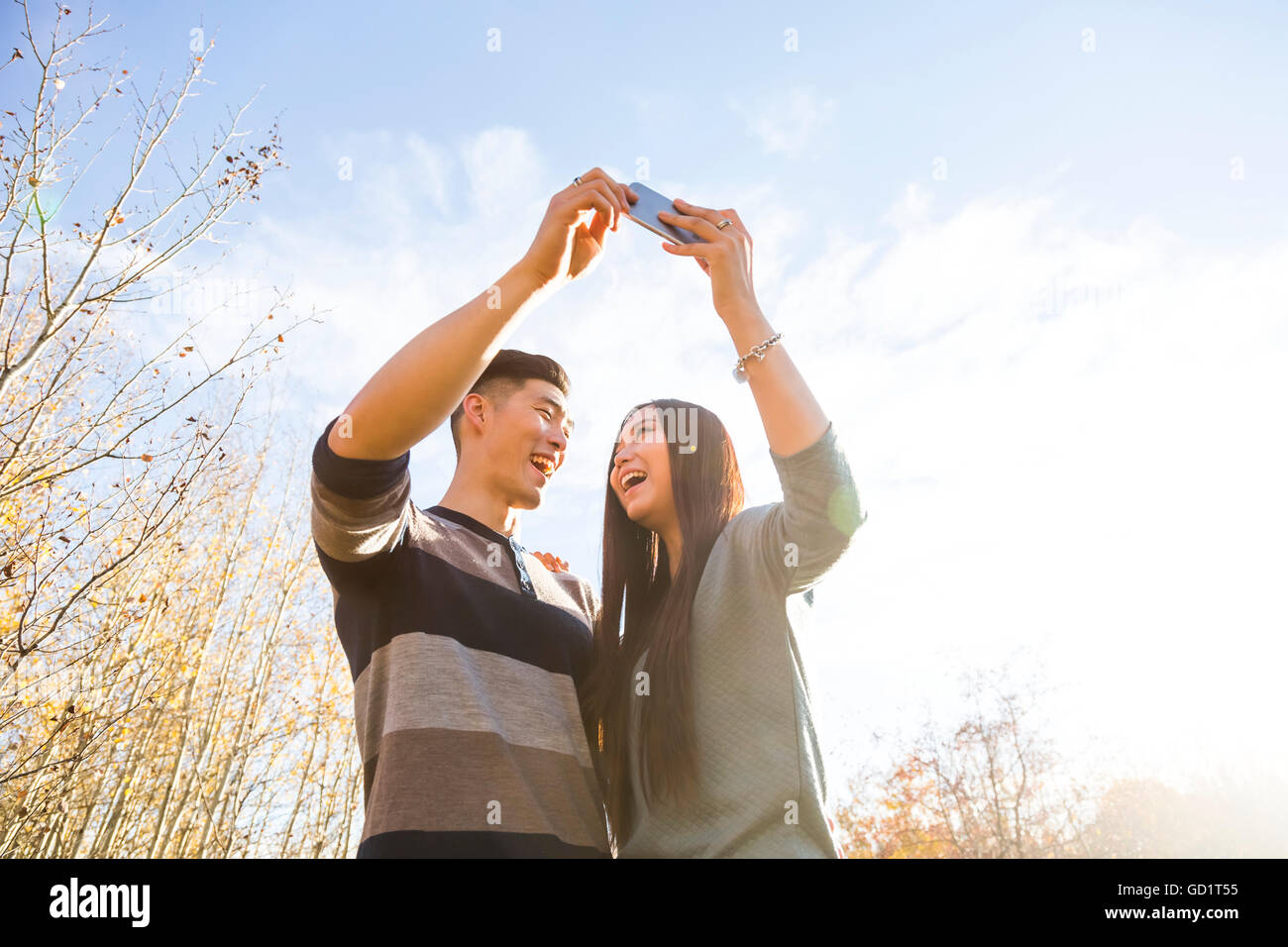 A Young Asian Couple Enjoying Quality Time Together Outdoors In A Park ...