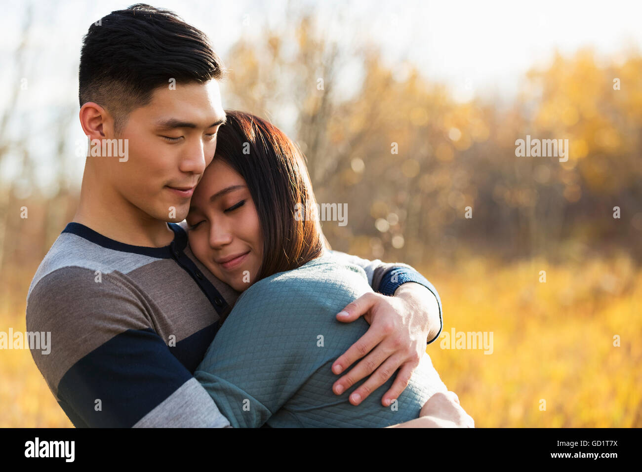 A Young Asian Couple Enjoying Quality Time Together Outdoors In A Park ...