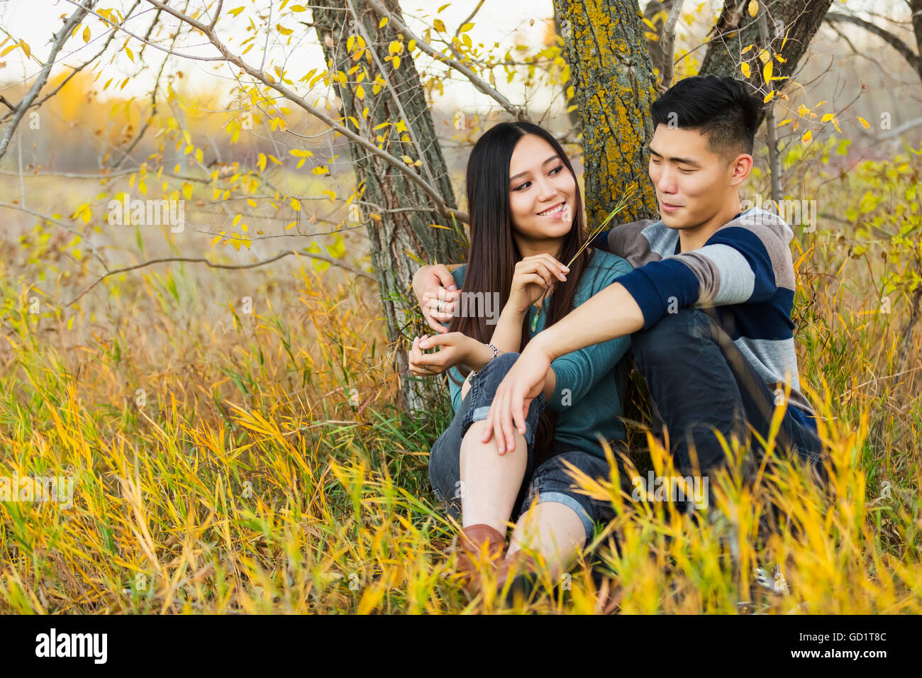 A Young Asian Couple Enjoying Quality Time Together Outdoors In A Park ...