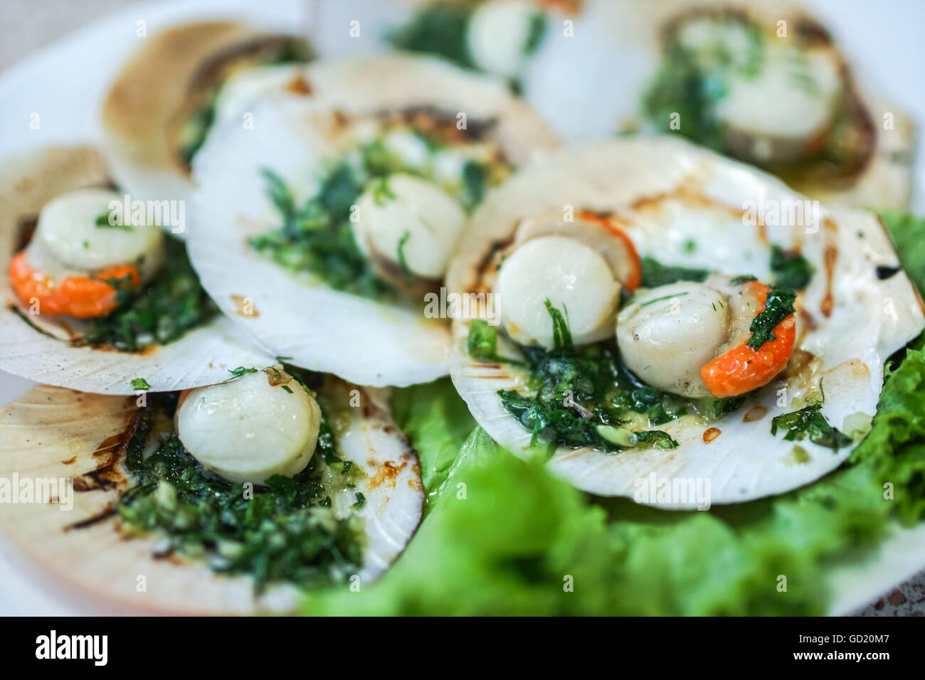 baked scallops with creamy herb butter sauce Stock Photo