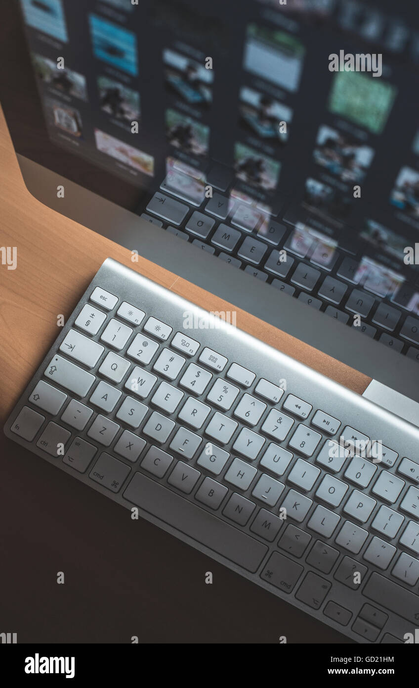 Many pictures on computer monitor. Keyboard Stock Photo Alamy