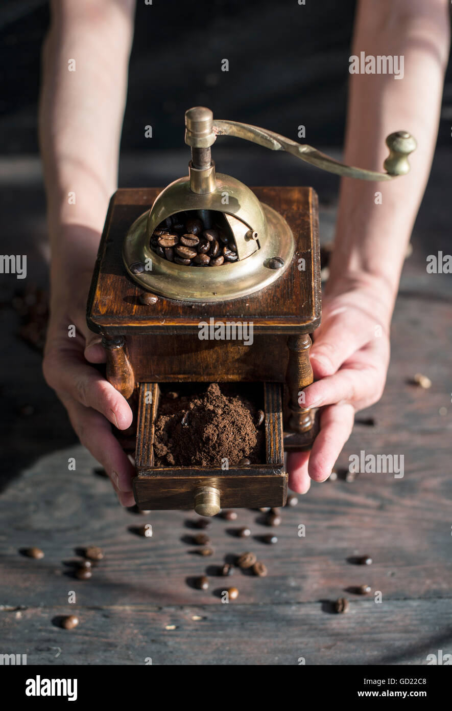 Grind coffee with vintage coffee grinder Stock Photo Alamy