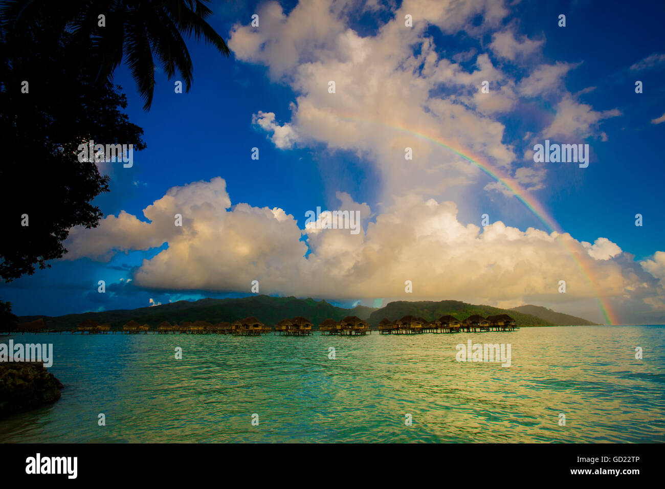Rainbow arcing over the overwater bungalows, Le Taha'a Resort, Tahiti, French Polynesia, South Pacific, Pacific Stock Photo