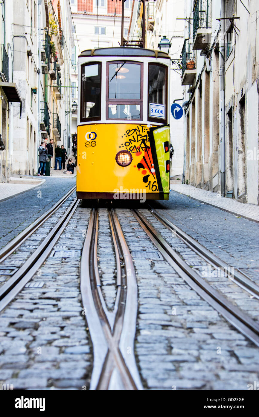 The characteristic yellow tram proceeds towards Bairro Alto, a central district of the old city of Lisbon, Portugal, Europe Stock Photo