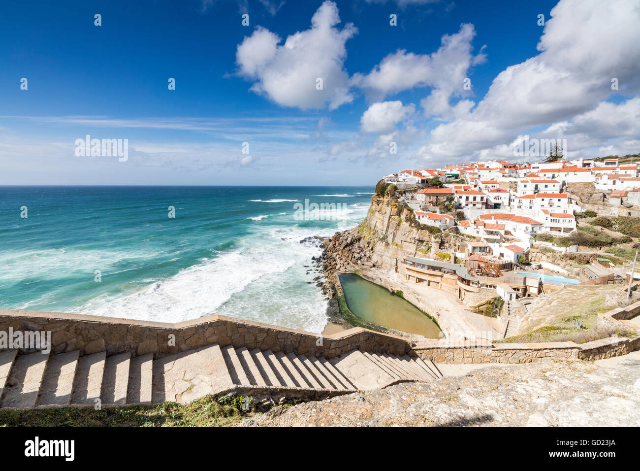 Top view of the perched village of Azenhas do Mar surrounded by the crashing waves of the Atlantic Ocean, Sintra, Portugal Stock Photo