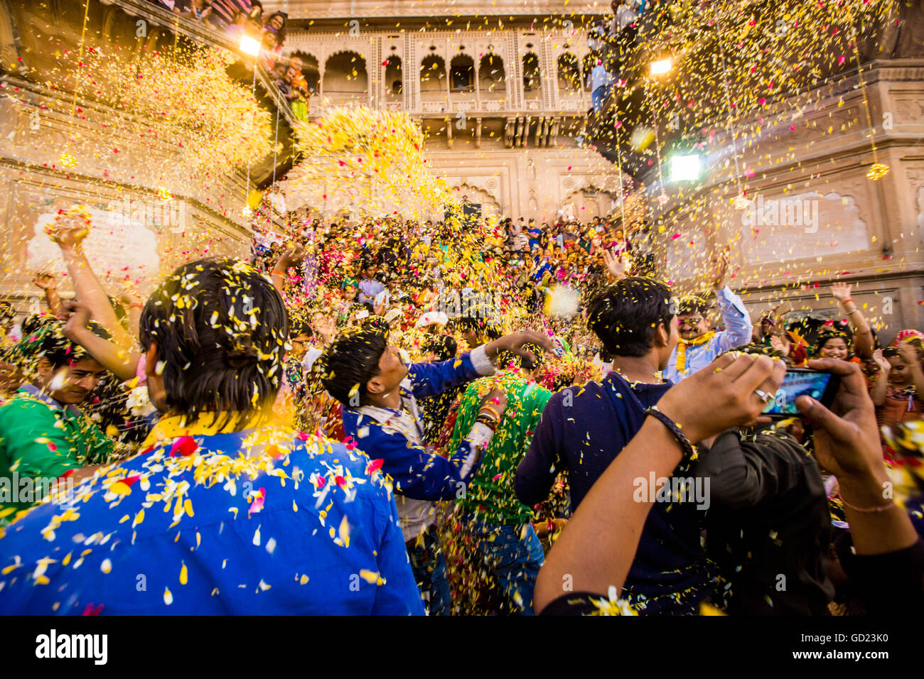 Crowd throwing flower petals during the Flower Holi Festival, Vrindavan
