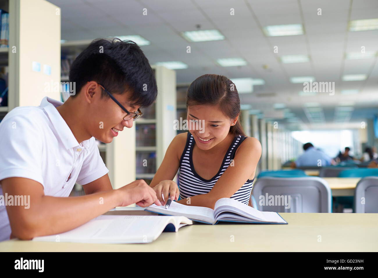 Young asian or Chinese college students study together in the library ...