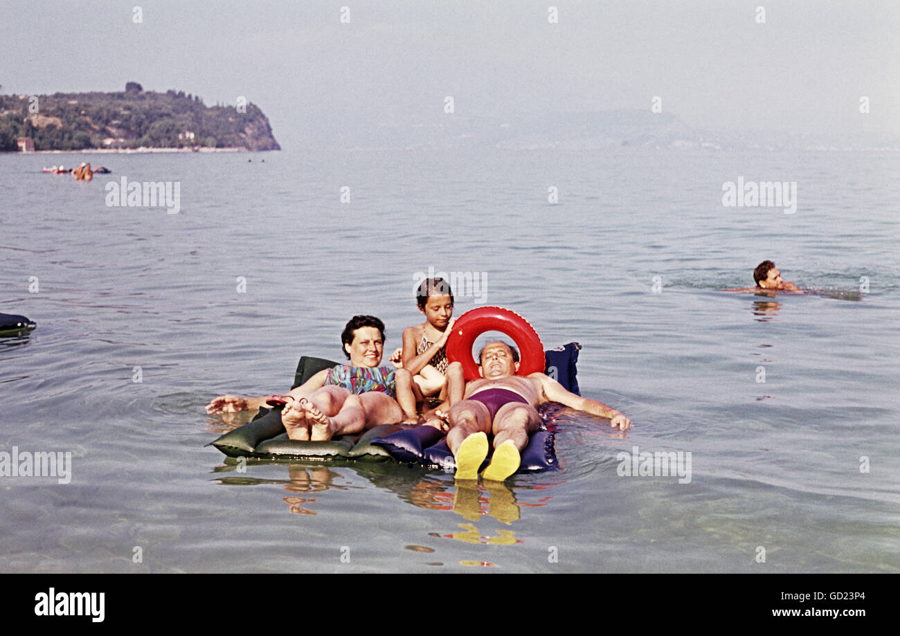 tourism, holidays, familiy with airbeds in the water, Lake Garda, Italy, 1962, Additional-Rights-Clearences-Not Available Stock Photo