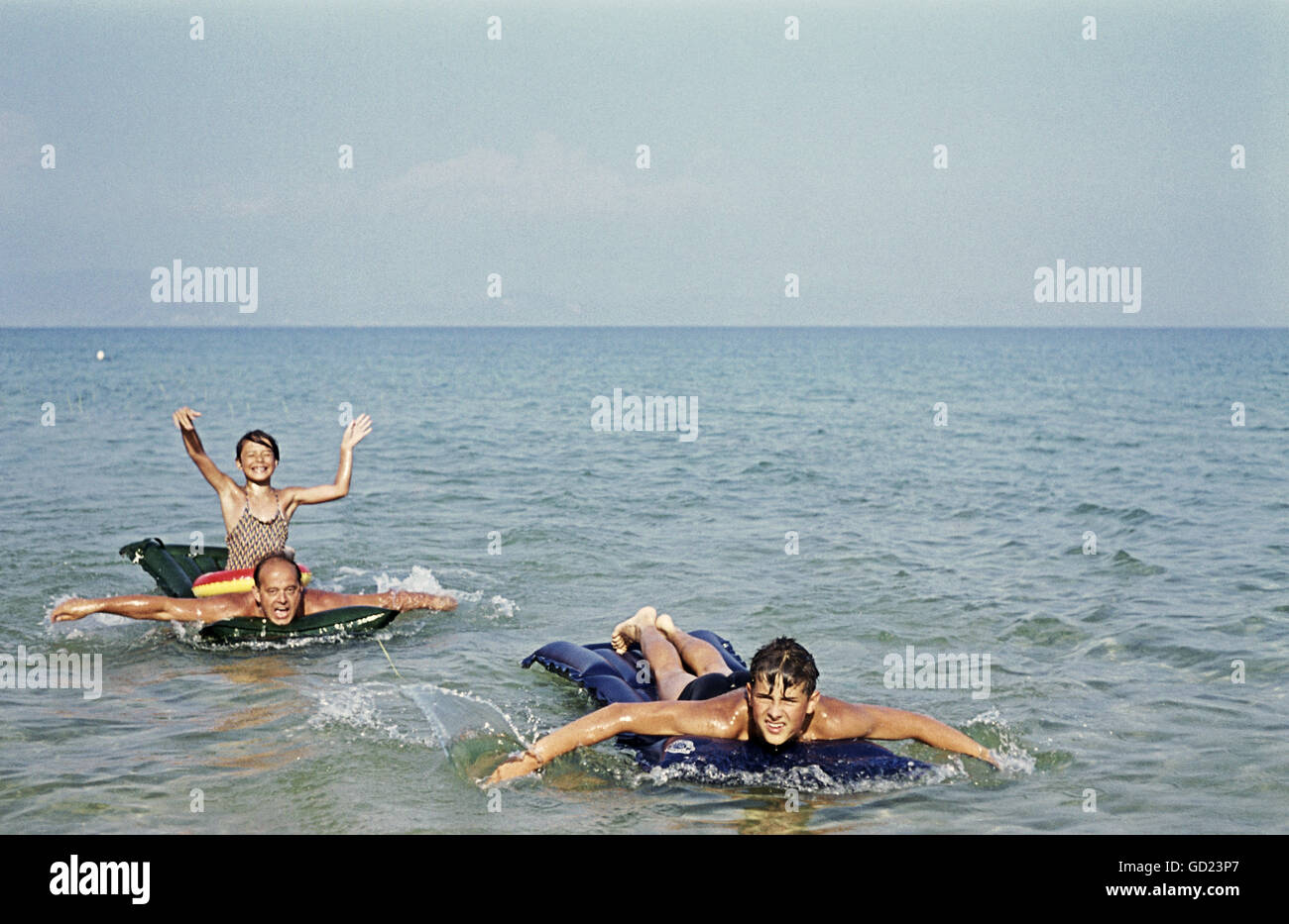 tourism, holidays, familiy with airbeds in the water, Lake Garda, Italy, 1962, Additional-Rights-Clearences-Not Available Stock Photo