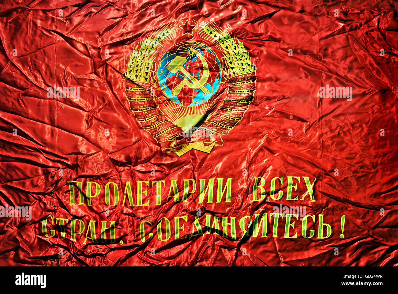 heraldry, coat of arms, flag with the Soviet national coat of arms, hammer and sickle on globe, inscription: Workers of the world, unite!, Soviet Union, circa 1977, Additional-Rights-Clearences-Not Available Stock Photo