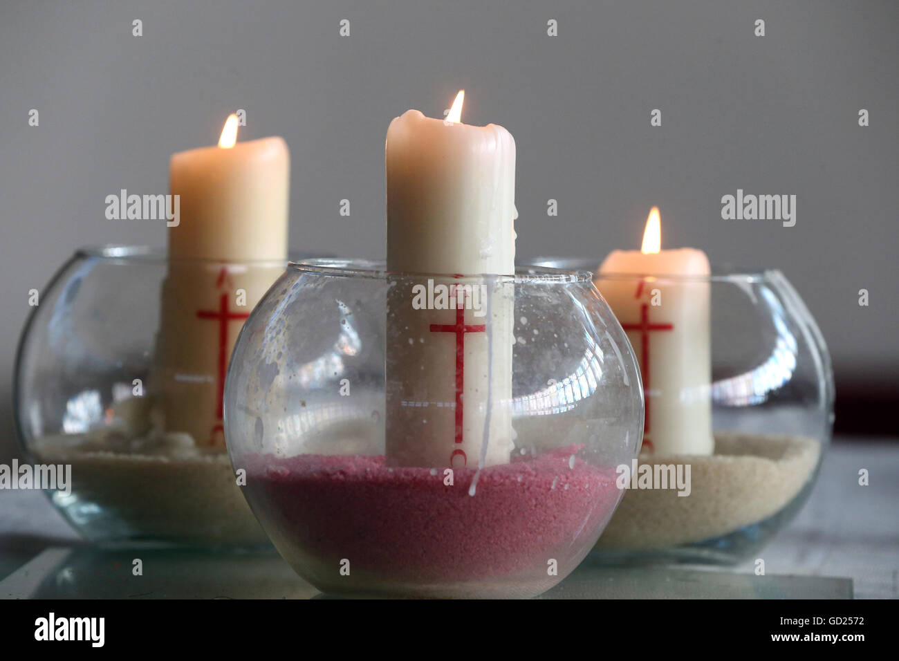 Three church candles in sand, Bussy-Saint-Georges, Seine-et-Marne, France, Europe Stock Photo