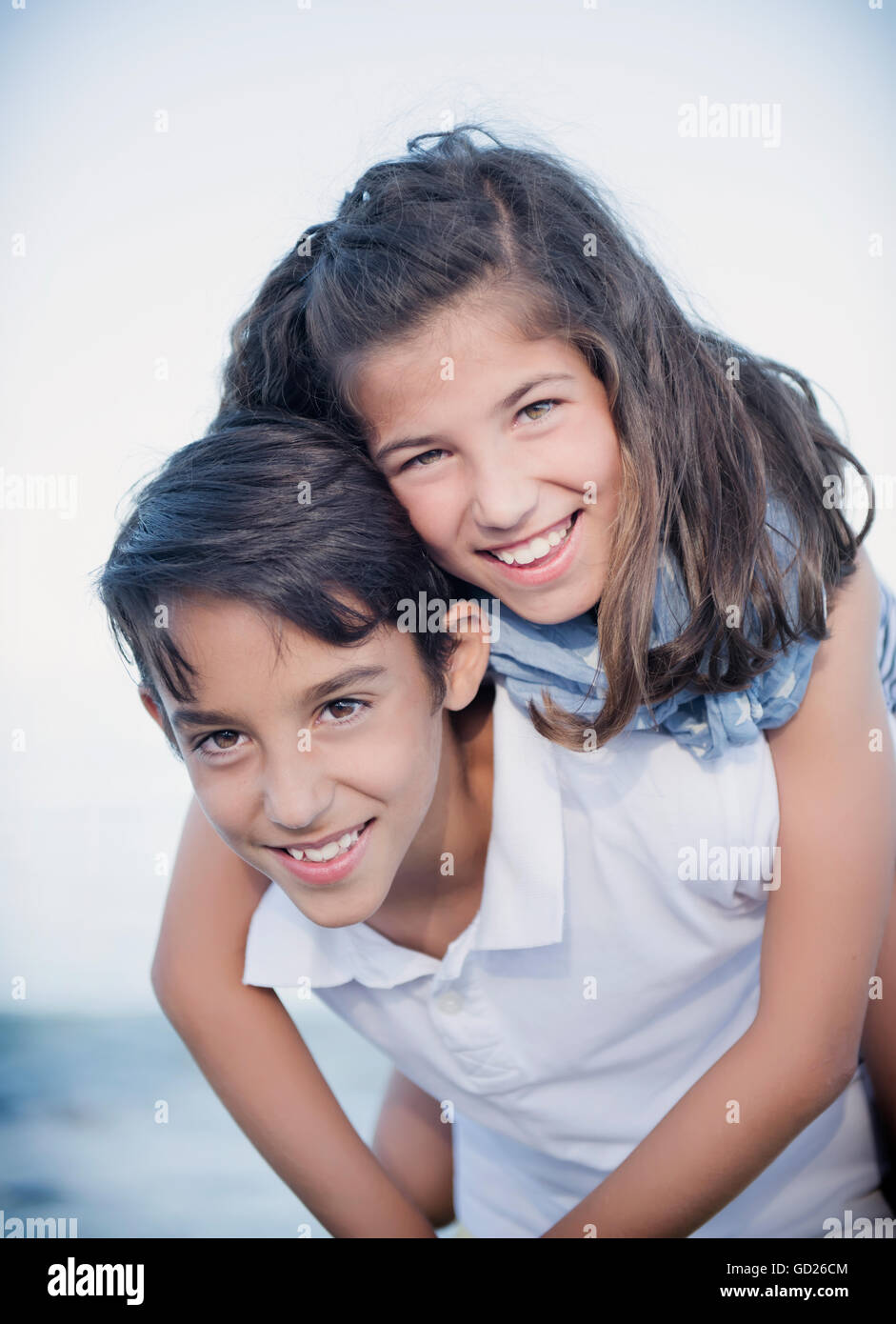 Cheerful cute boy and girl playing outdoors Stock Photo