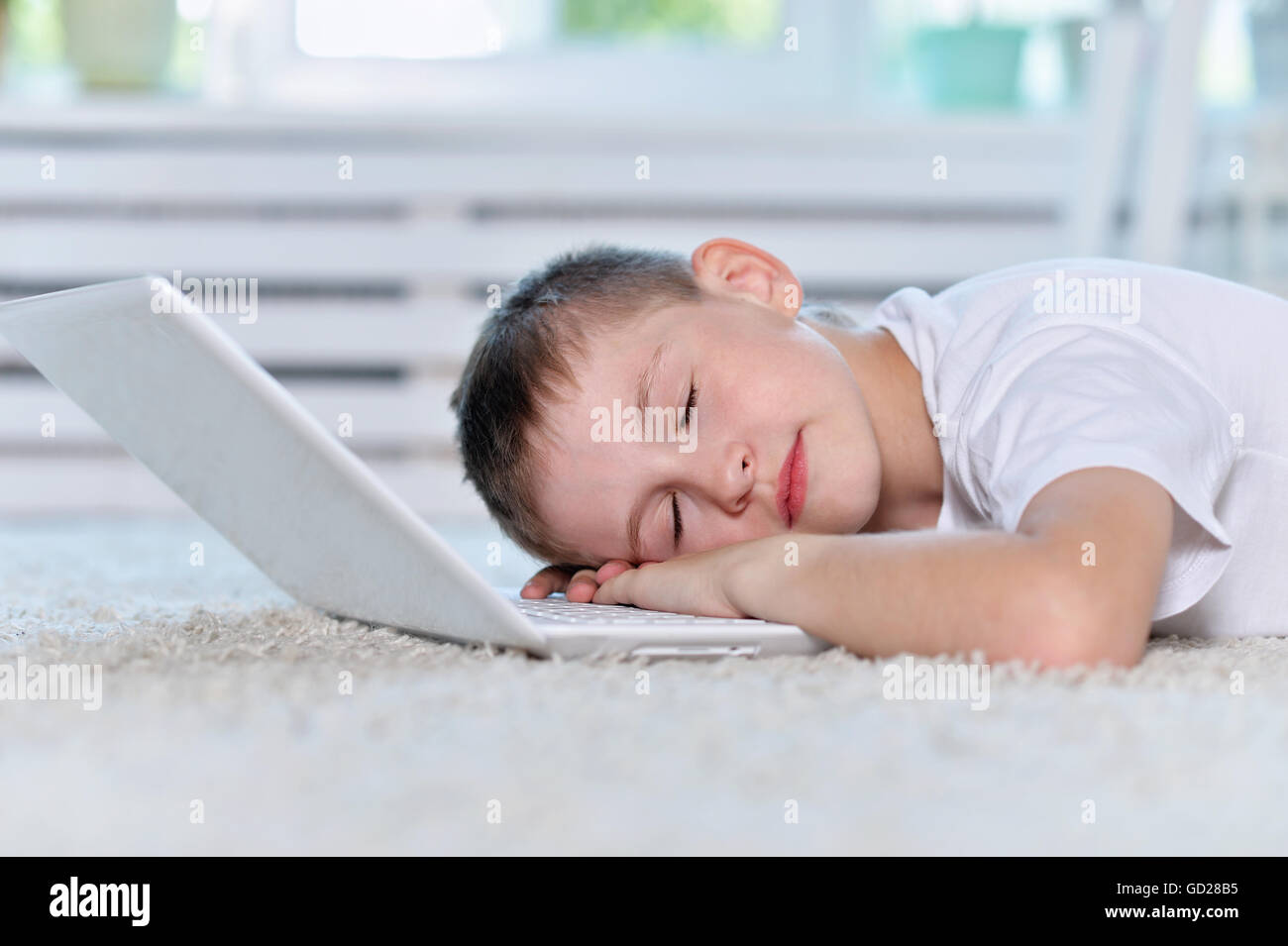 boy sleeping near and laptop Stock Photo Alamy