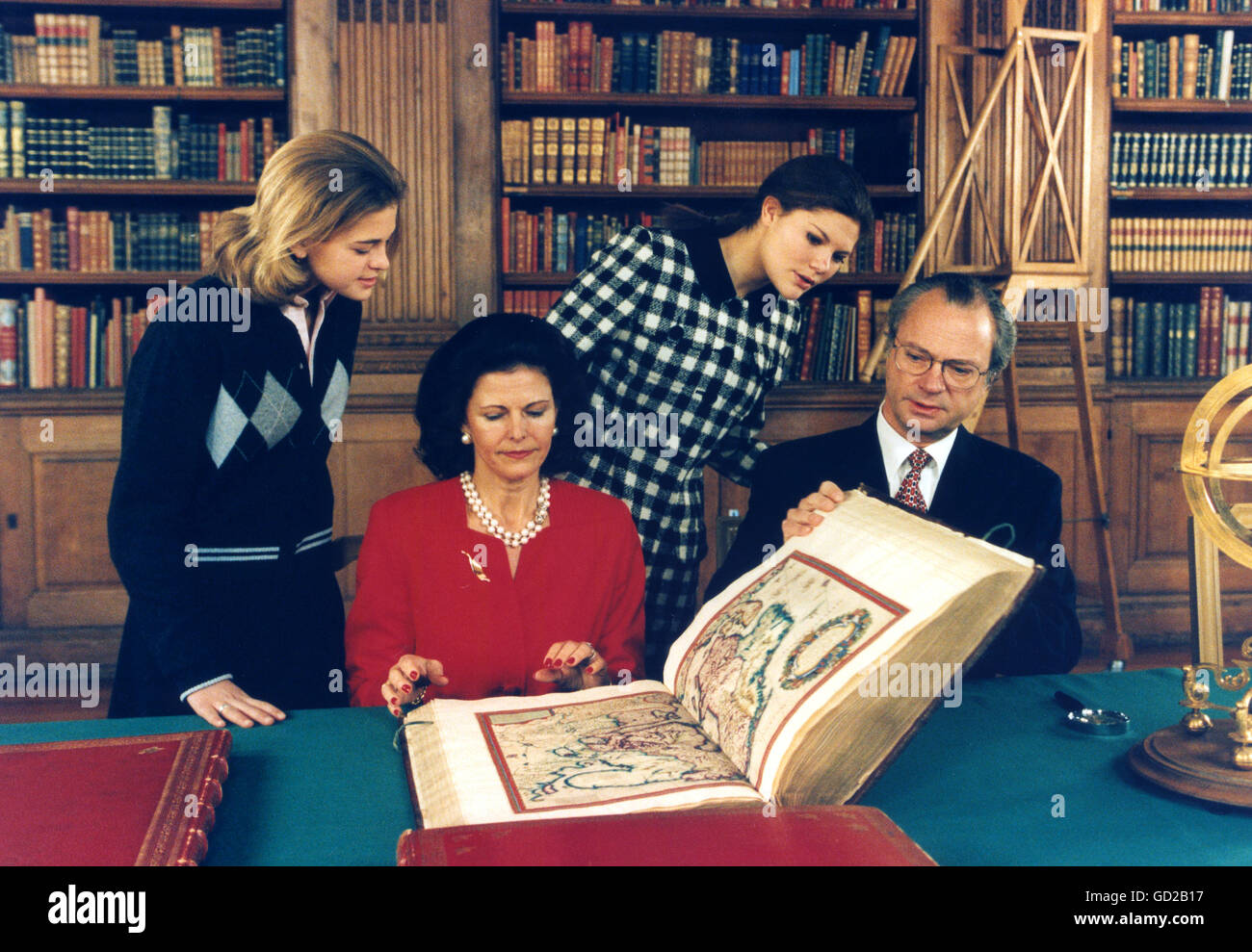 ROYAL FAMILY except Prince Carl Philip at Bernadotte Library at Royal Palace looking in old atlas Stock Photo
