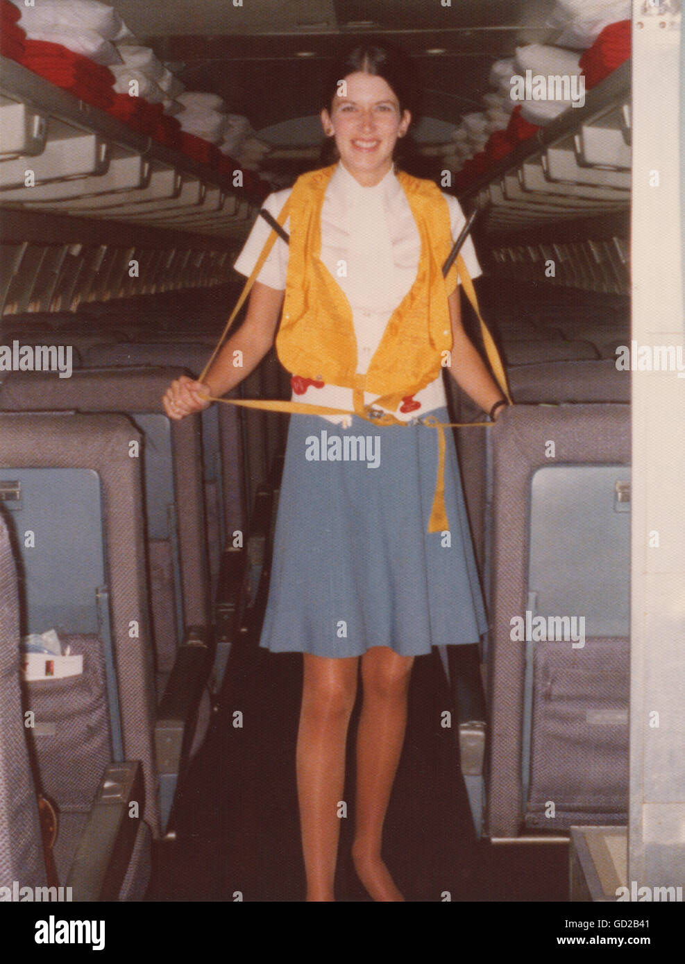 Pan American Airlines Flight Stewardess  Giving on Board  707 Safety Announcement Wearing Yellow Life Vest, 1973, USA Stock Photo