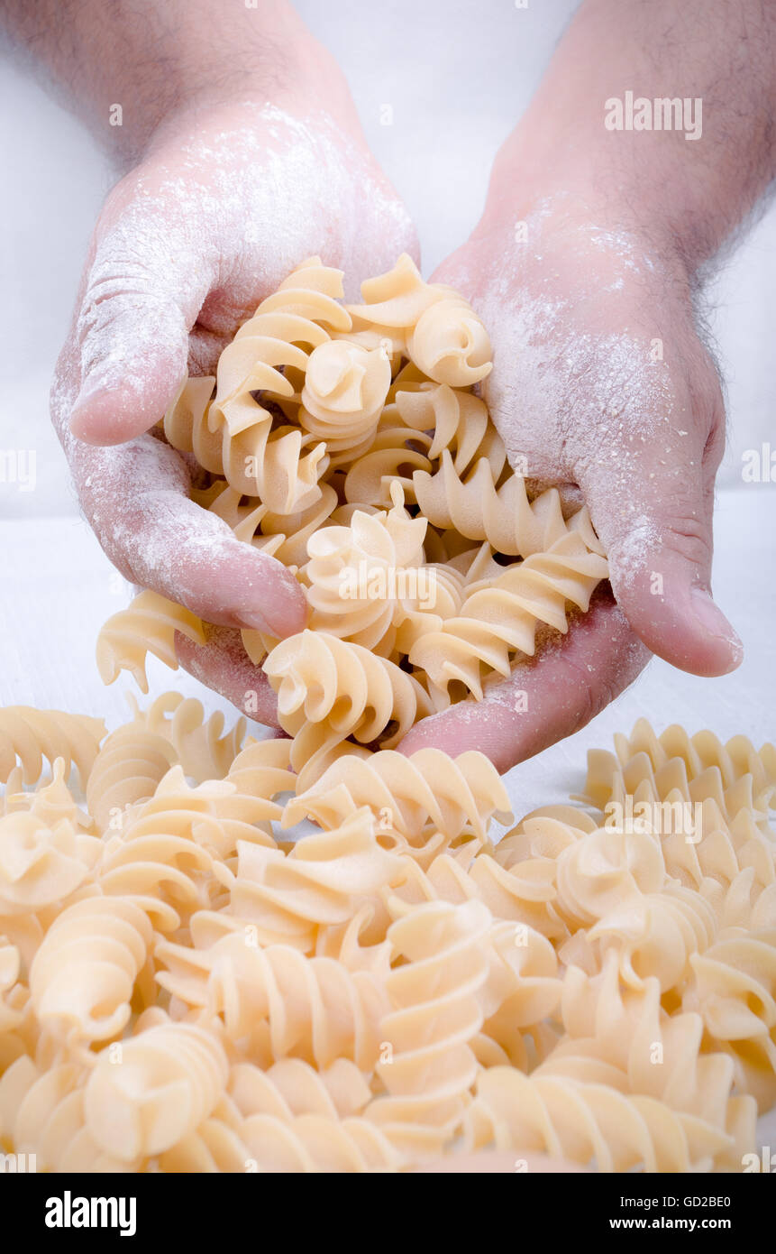 Male hands holding handmade rustic pasta Stock Photo - Alamy