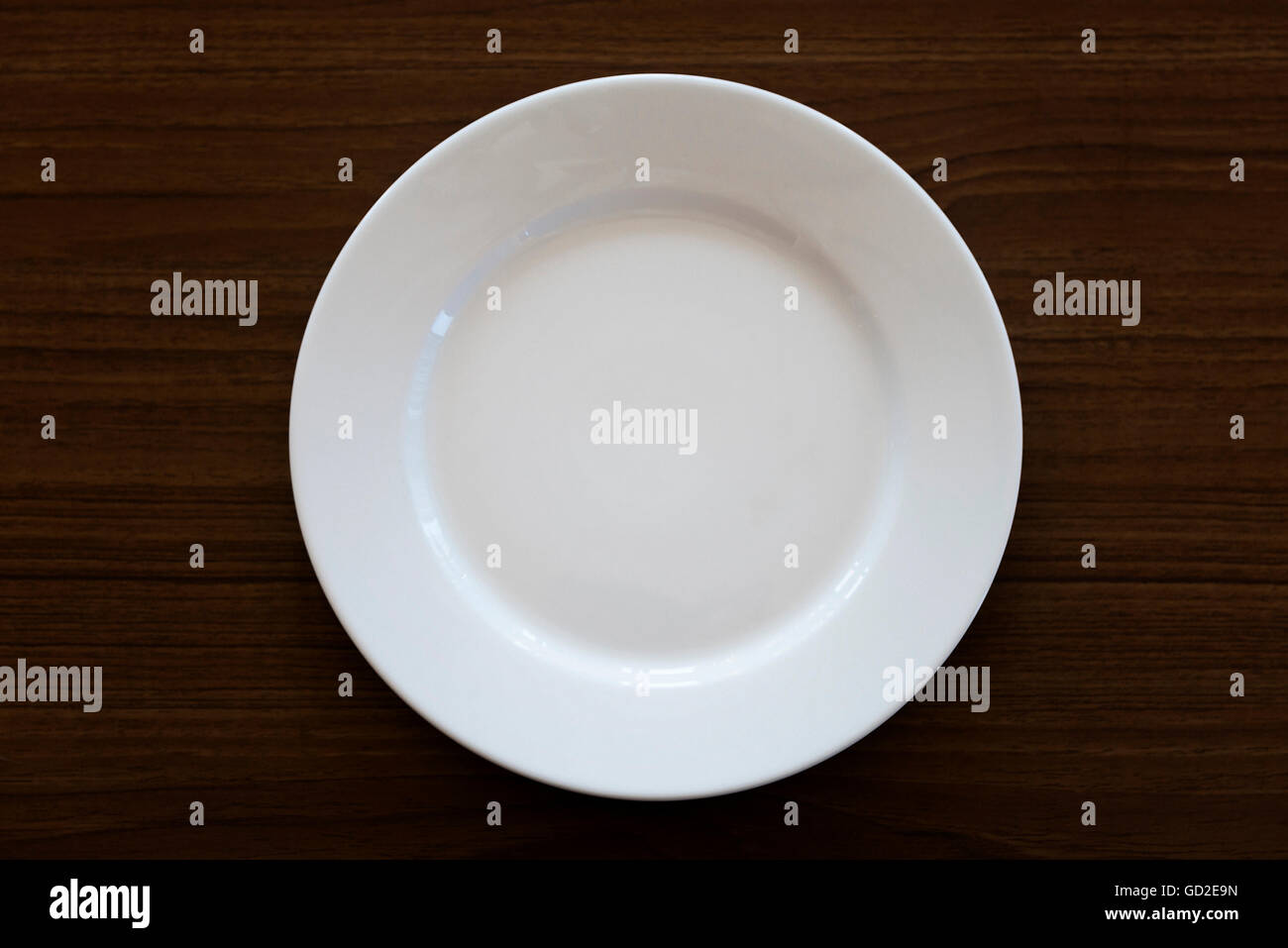 Empty White Porcelain Dish on Wood Table Stock Photo