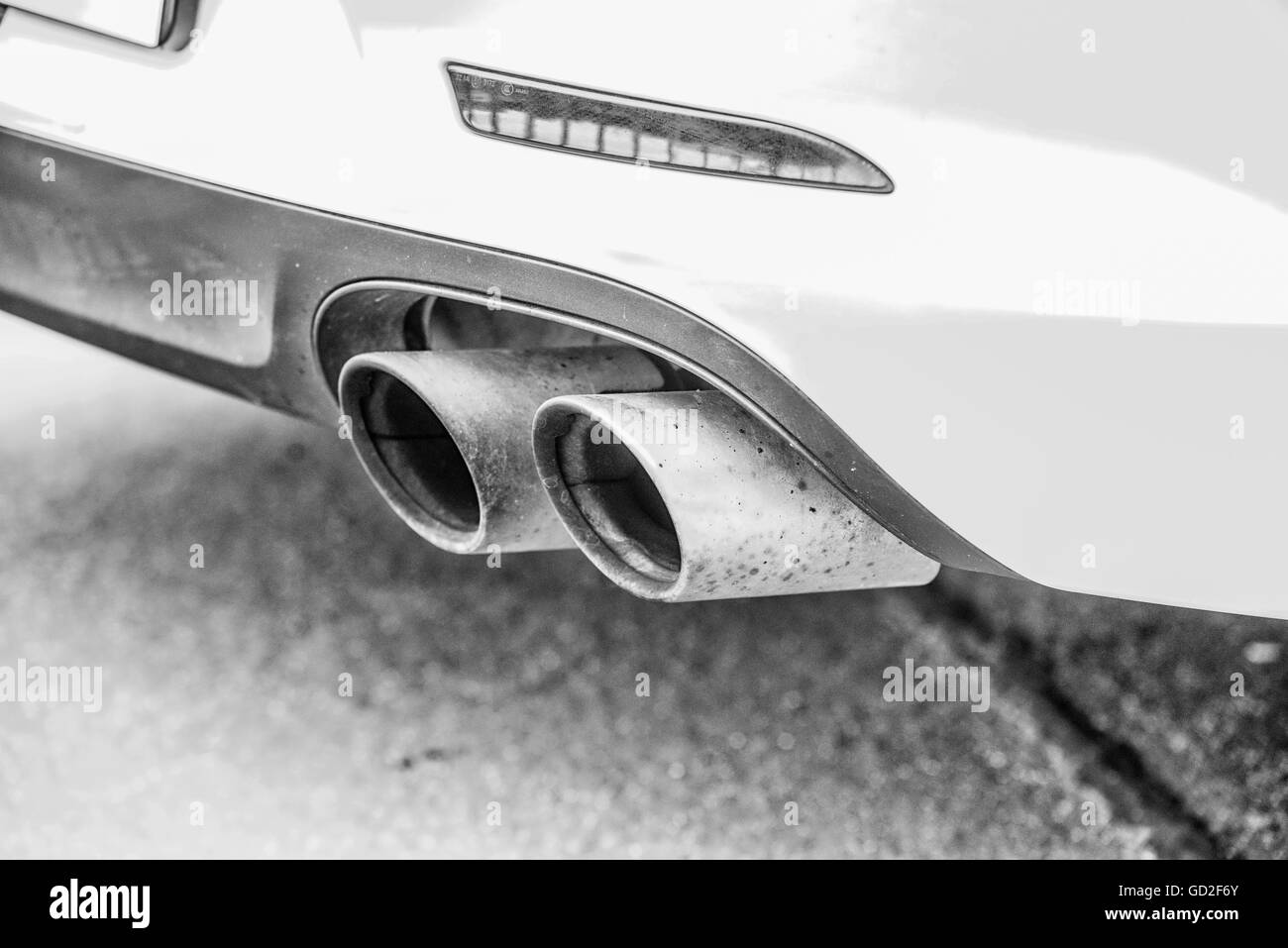 Double exhaust pipes of a modern sports car, black and white Stock Photo
