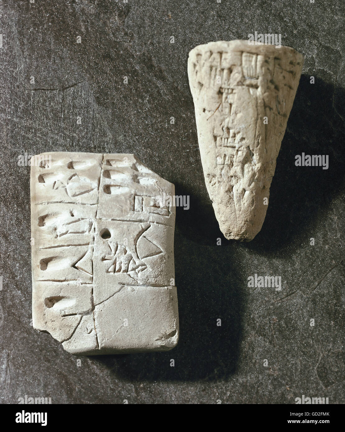 writing, script, cuneiform script, Uruk, left: list of articles, Sumerian, 3300 / 3200 BC, clay, National Museum Baghdad, Iraq, right: nail with inscription, Babylonian, 1860 / 1833 BC, clay, State Archaeological Collection, Munich, administration, inscription, inscriptions, clay tablet, goods, lists, Babylon, Sumer, Mesopotamia, prehistory, prehistoric times, historic, historical, ancient world, Additional-Rights-Clearences-Not Available Stock Photo