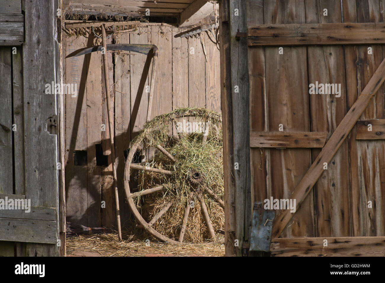 agriculture, barn, cartwheel from the 19th century, Bavaria, near Chams, Germany, wheel, wheels, scythe, scythes, barn door, barn doors, open, insight, insights, farm, farms, country life, agriculture, farming, wood, hovel, hovels, shack, shacks, barn floor, barn floors, agricultural, agrarian, appliances, tradition, traditions, still life, stilllife, rake, rakes, thing, things, barn, barns, cartwheel, cartwheels, historic, historical, Additional-Rights-Clearences-Not Available Stock Photo